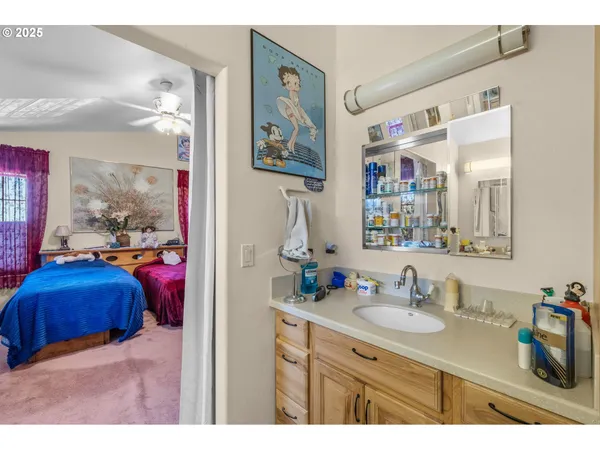 a en suite bathroom with a sink double vanity and a mirror