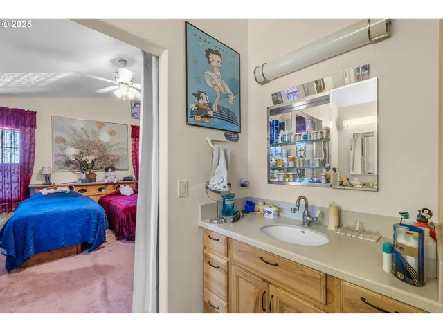 a en suite bathroom with a sink double vanity and a mirror