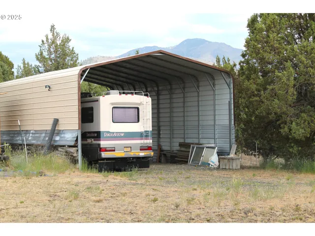 a backyard of a house with barbeque oven