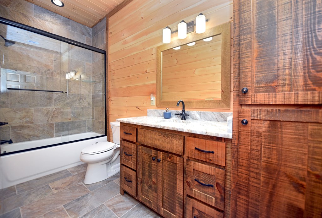 306 Native Trail Cherry Log, GA 30522 - Photo 59 of 65 a bathroom with a sink a toilet and shower