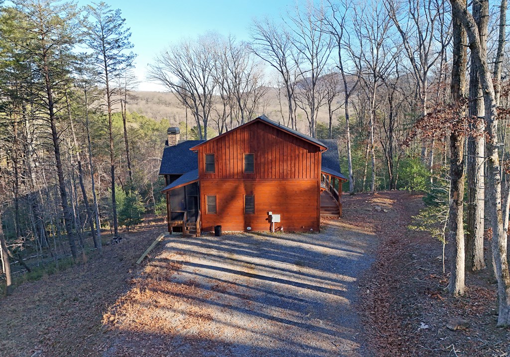 306 Native Trail Cherry Log, GA 30522 - Photo 6 of 65 a backyard of a house with large trees and outdoor seating