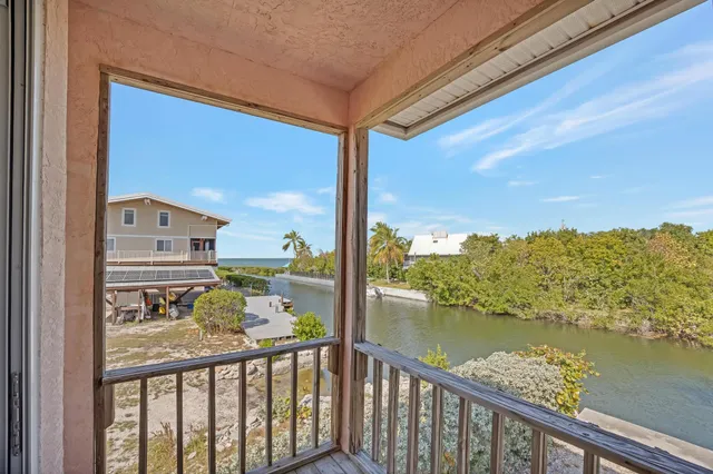 a kitchen with granite countertop a stove a refrigerator and a sink