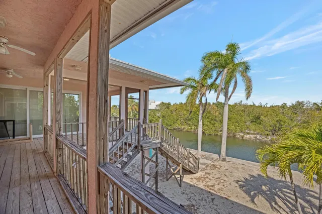a kitchen with a sink a stove and cabinets