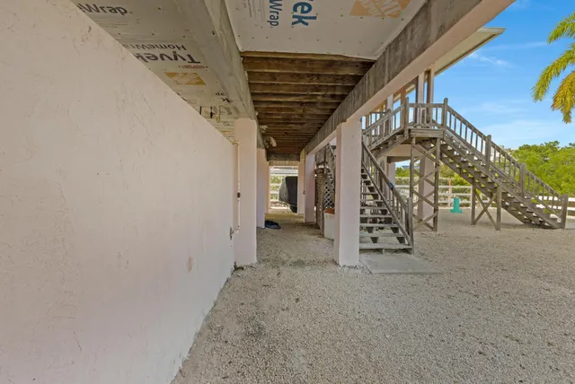 a living room with furniture a flat screen tv and a large window