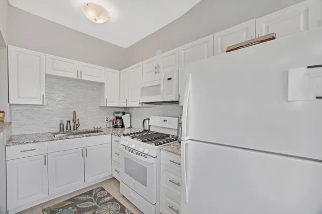 a bathroom with a sink mirror toilet and shower