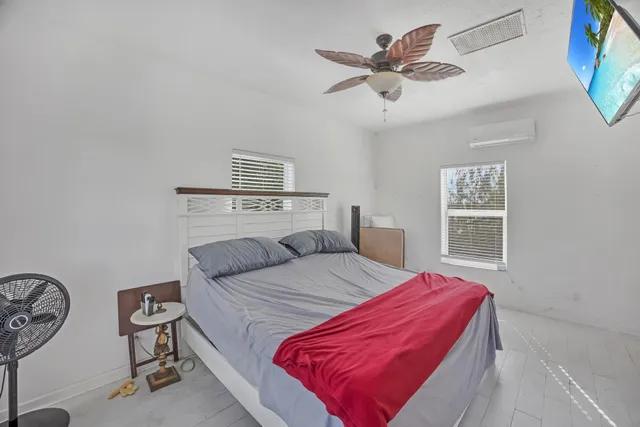 an aerial view of ocean and residential houses with outdoor space