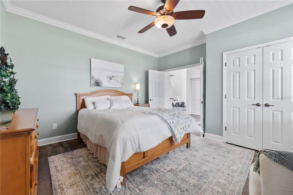 16948 Deer Island Road Tavares, FL 32778 - Photo 25 of 67 a bedroom with a bed and a chandelier
