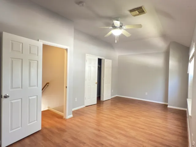 wooden floor in an empty room with a mirror