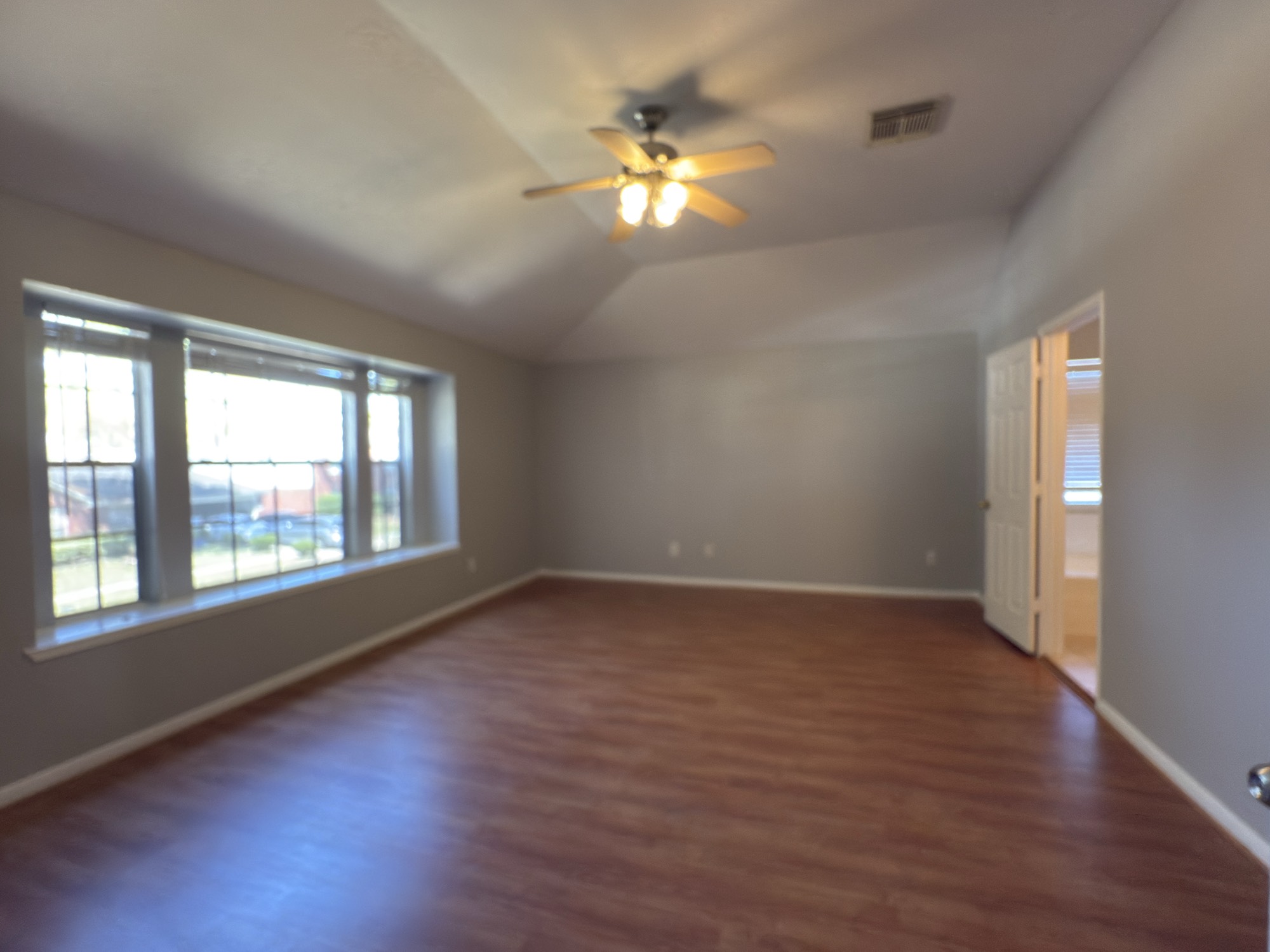 14431 Andrea Way Lane Houston, TX 77083 - Photo 13 of 20 an empty room with wooden floor and windows