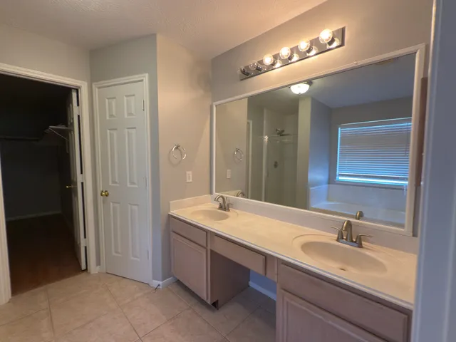 a bathroom with a sink double vanity and a mirror