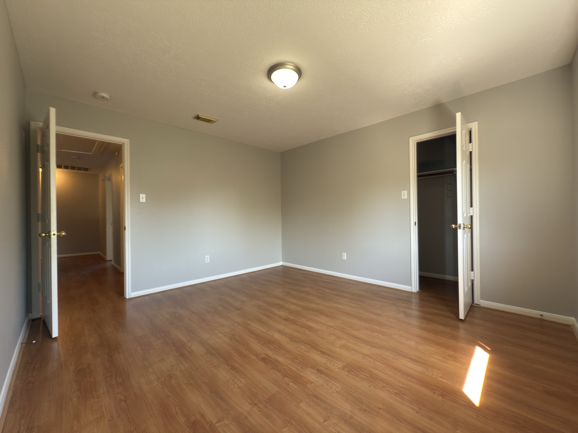 14431 Andrea Way Lane Houston, TX 77083 - Photo 20 of 20 an empty room with wooden floor and windows