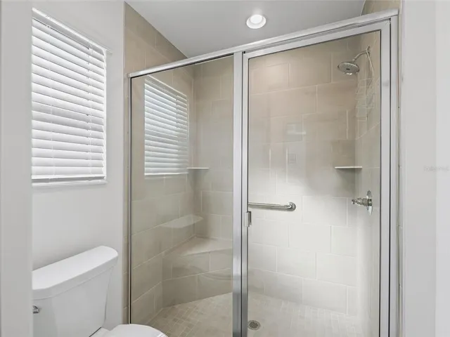 a bathroom with a shower and a toilet