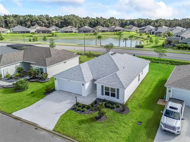 an aerial view of a house with big yard and a garden