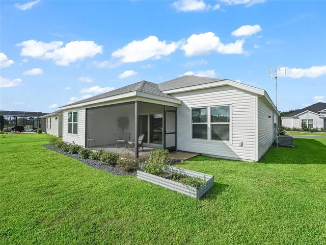 a view of a house with a yard and a garden