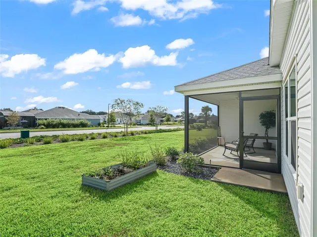 a view of a house with backyard porch and garden