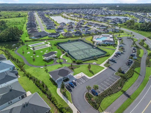 an aerial view of a house with a garden and swimming pool