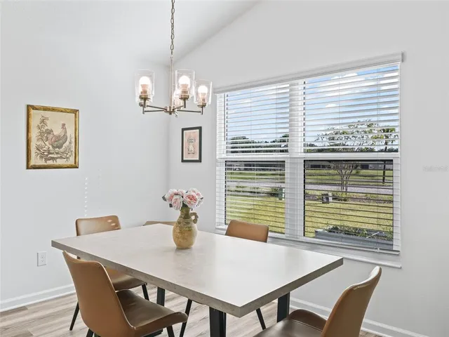 a view of a dining room with furniture and window