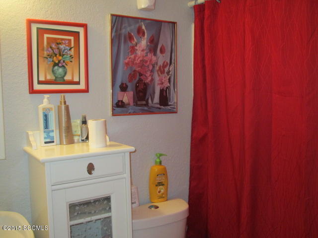 1171 Circulo Golfo Rio Rico, AZ 85648 - Photo 10 of 17 a bathroom with a sink a mirror and painting on the wall