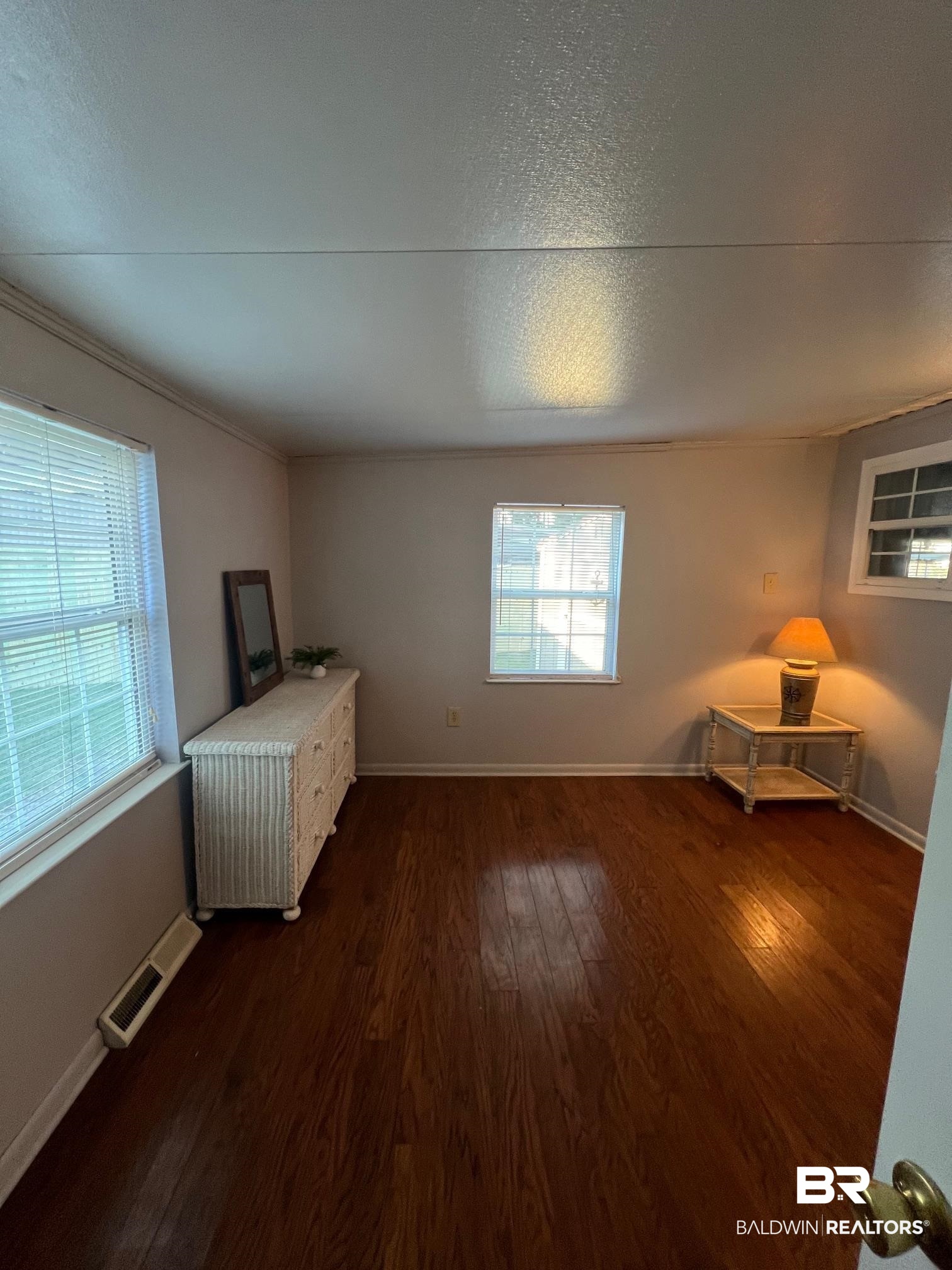 698 Escambia Loop Lillian, AL 36549 - Photo 11 of 16 Interior space featuring ornamental molding and dark hardwood / wood-style flooring