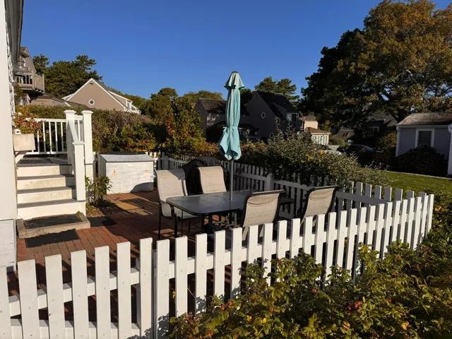 a view of a brick house with wooden fence