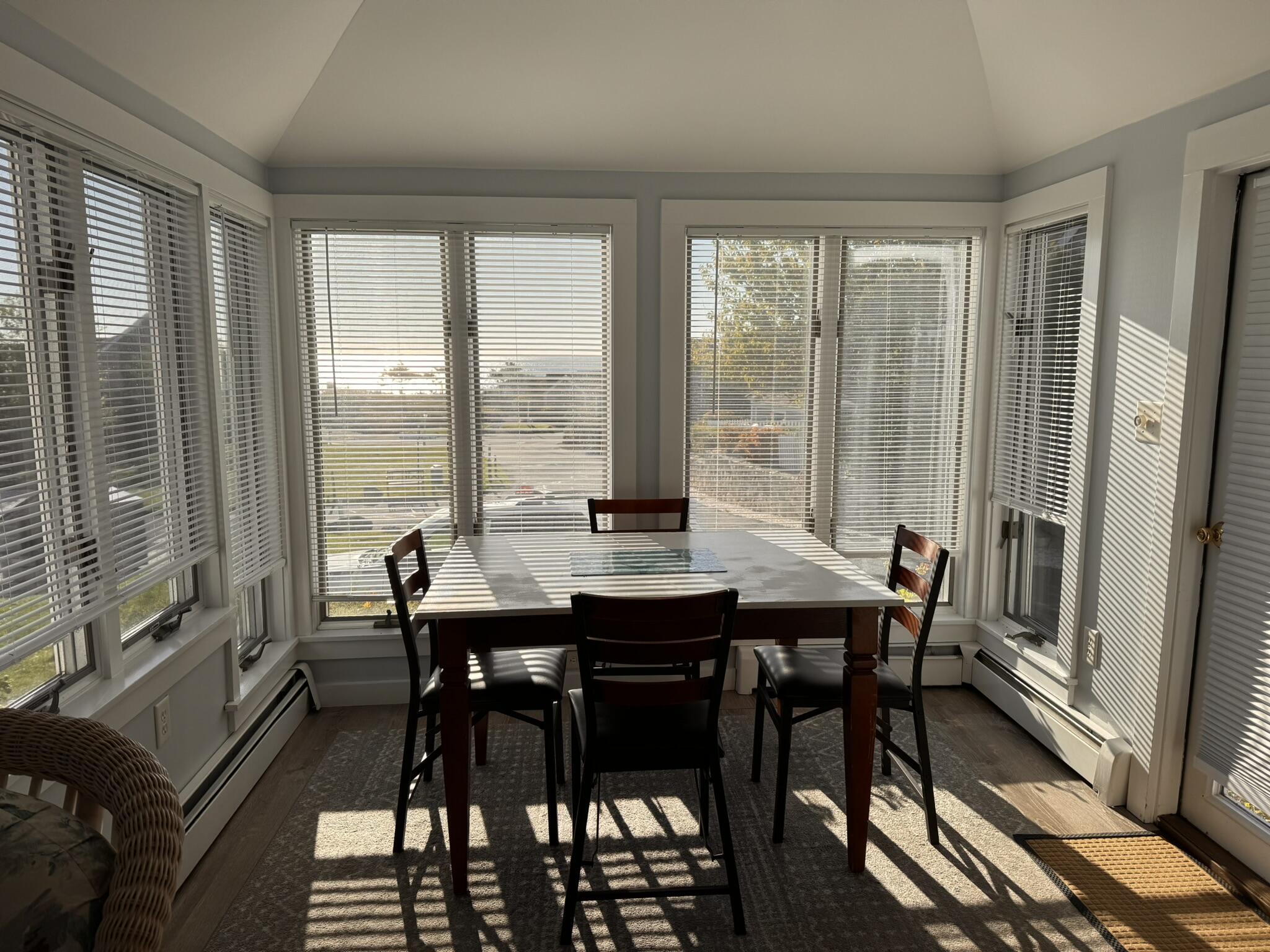 11 Brant Rock Road, Unit 11 Mashpee, MA 02649 - Photo 4 of 9 a view of a dining room with furniture window and wooden floor
