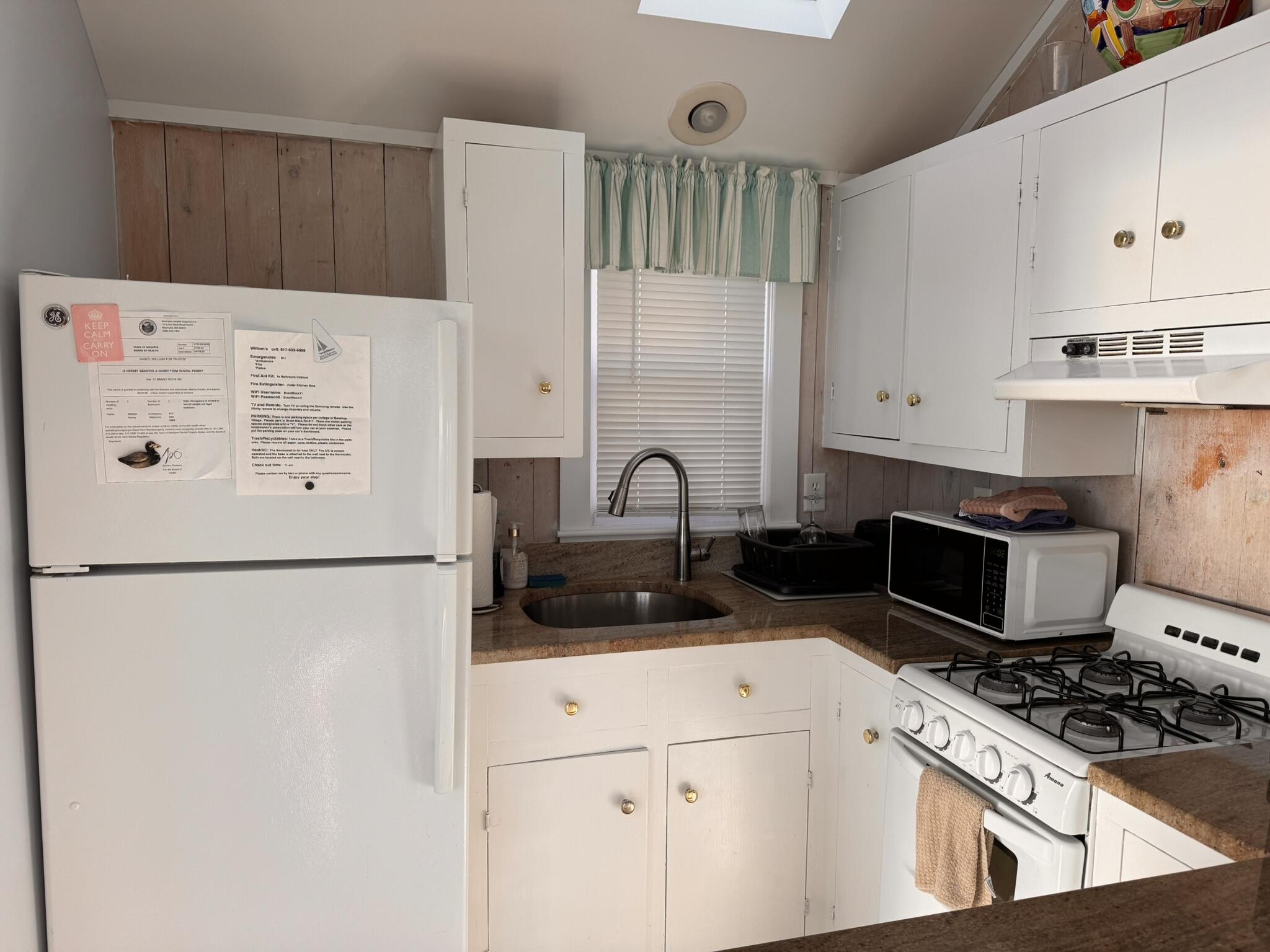 11 Brant Rock Road, Unit 11 Mashpee, MA 02649 - Photo 5 of 9 a kitchen with stainless steel appliances a refrigerator stove and white cabinets