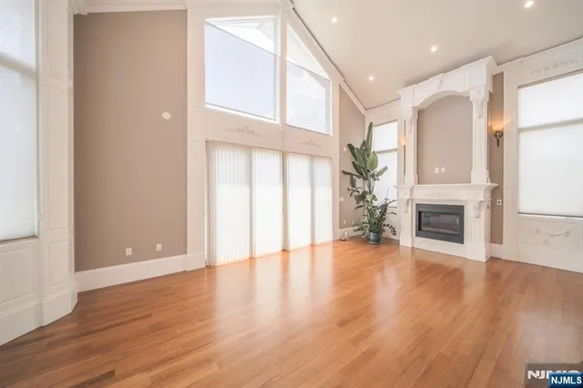 a view of a livingroom with wooden floor and a fireplace
