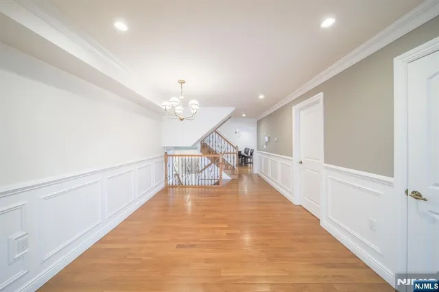a view of a livingroom with a ceiling fan and wooden floor
