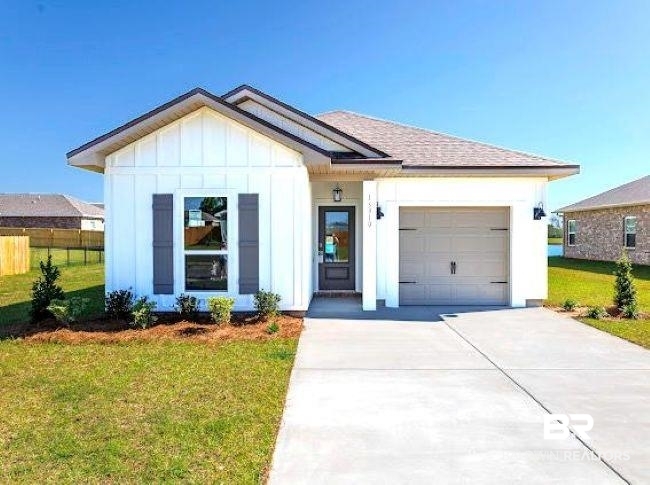 16810 Rocher Court Foley, AL 36535 - Photo 1 of 24 Contemporary single-story residence featuring white board and batten siding, gray shutters, and a gray shingle roof