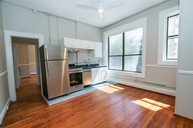 a kitchen with stainless steel appliances a refrigerator sink and microwave