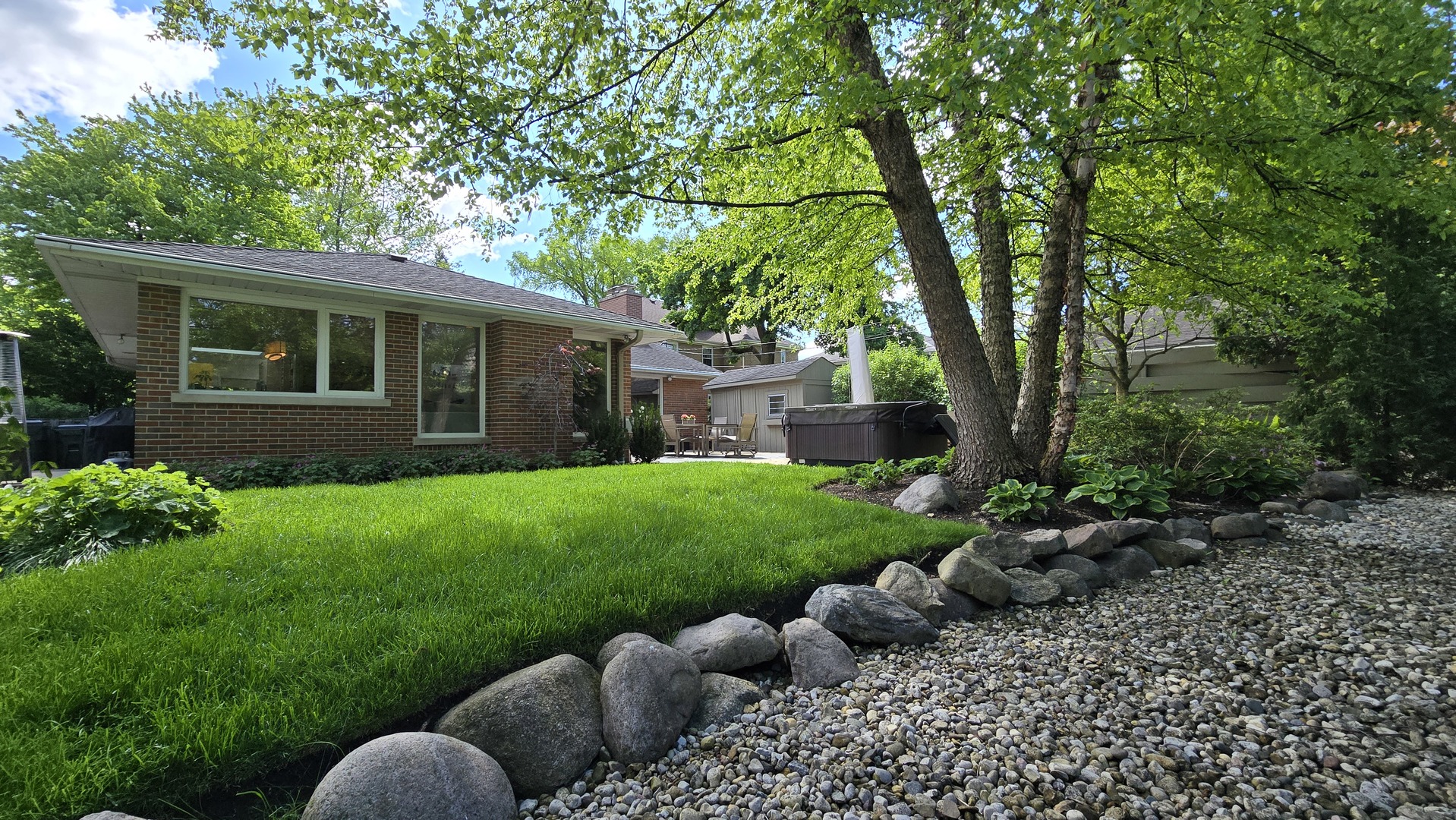 a view of house with backyard and outdoor seating