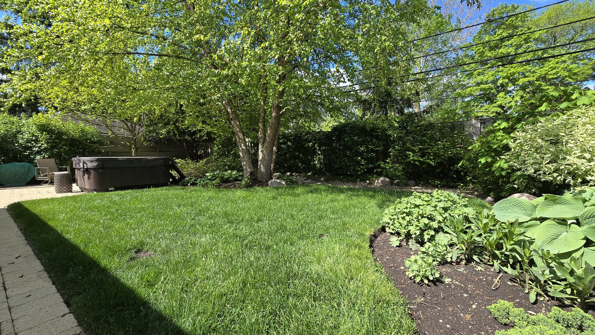 906 Lenox Road Glenview, IL 60025 - Photo 4 of 6 a view of a garden with a bench