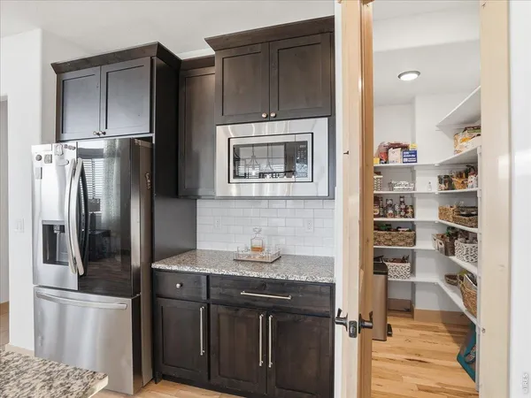 a kitchen with stainless steel appliances granite countertop a refrigerator and a sink