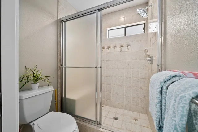 a bedroom with bed and window