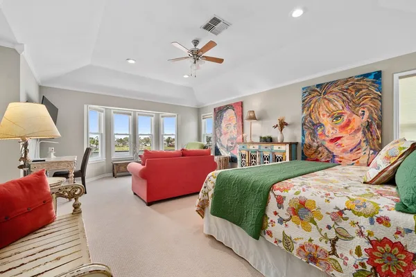 a bedroom with a bed and a painting on the wall