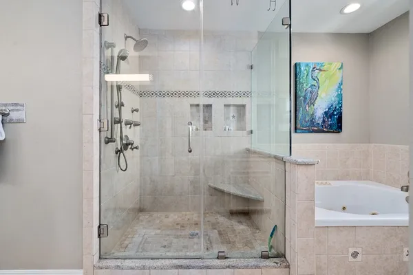 a bathroom with a double vanity sink mirror and shower