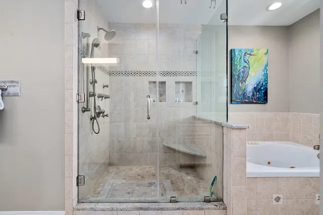 a bathroom with a double vanity sink mirror and shower