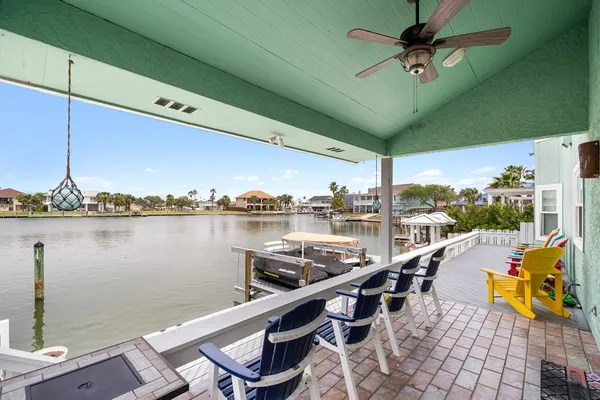 a view of a lake with couches chairs