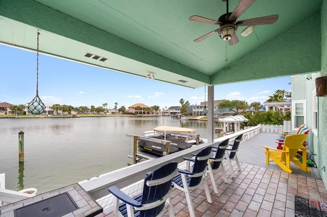 a view of a lake with couches chairs