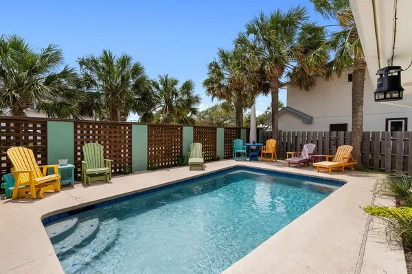 a view of swimming pool with chairs