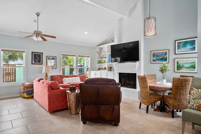 a living room with furniture a flat screen tv and a fireplace