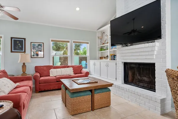 a living room with furniture a fireplace and a flat screen tv