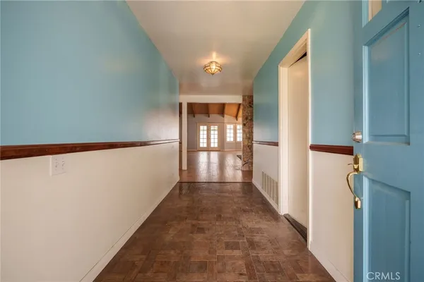 a view of a livingroom with furniture and an empty room