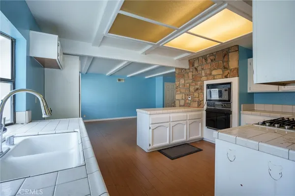a view of a kitchen with a sink cabinets and a floor to ceiling window