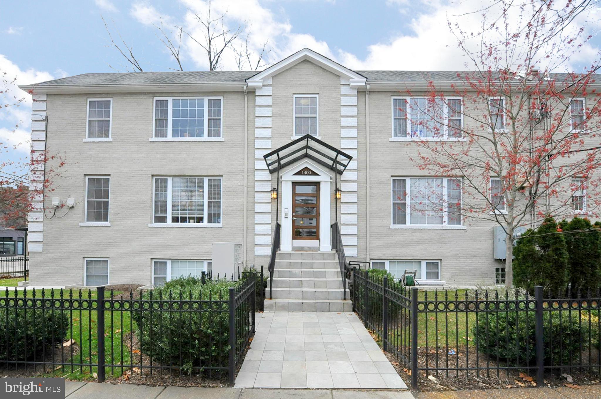 1400 Longfellow Street Northwest, Unit 101 Washington, DC 20011 - Photo 1 of 14 a front view of a house with a garden