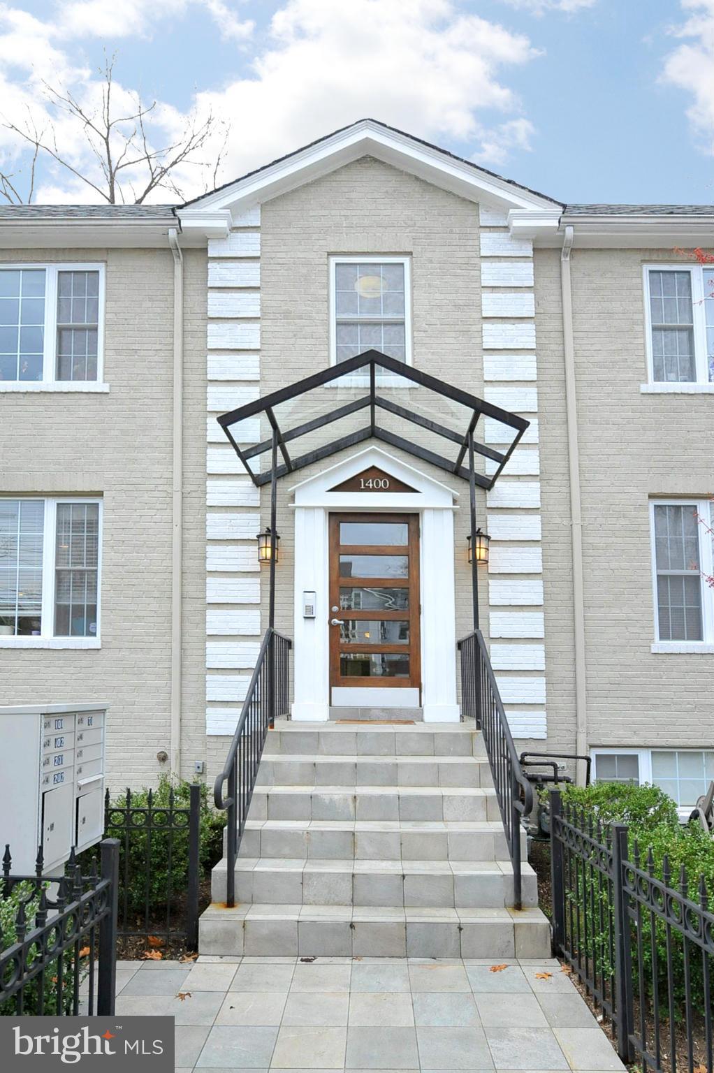 1400 Longfellow Street Northwest, Unit 101 Washington, DC 20011 - Photo 2 of 14 a front view of a house with stairs