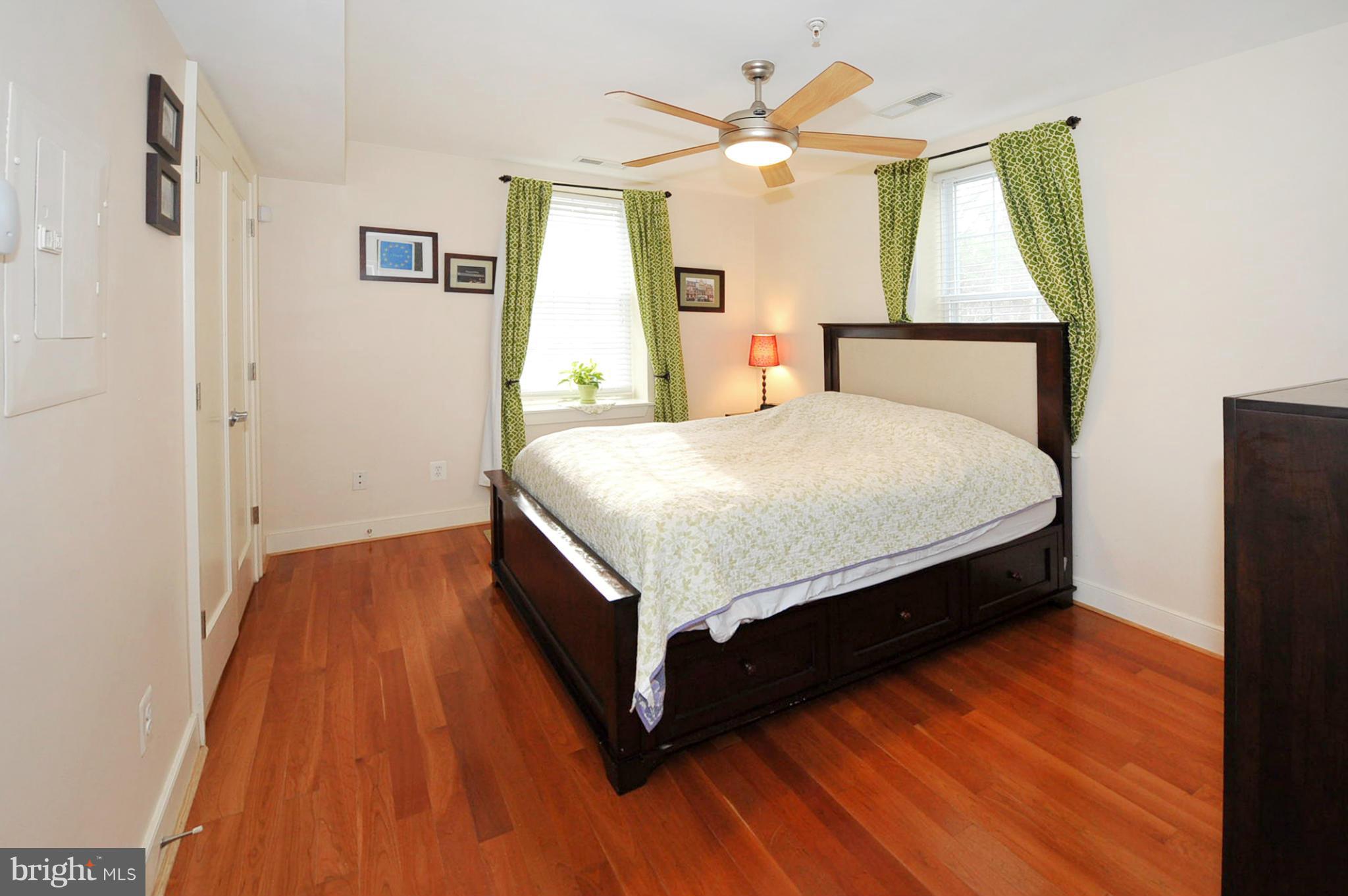 1400 Longfellow Street Northwest, Unit 101 Washington, DC 20011 - Photo 11 of 14 a bed sitting in a bedroom next to a window