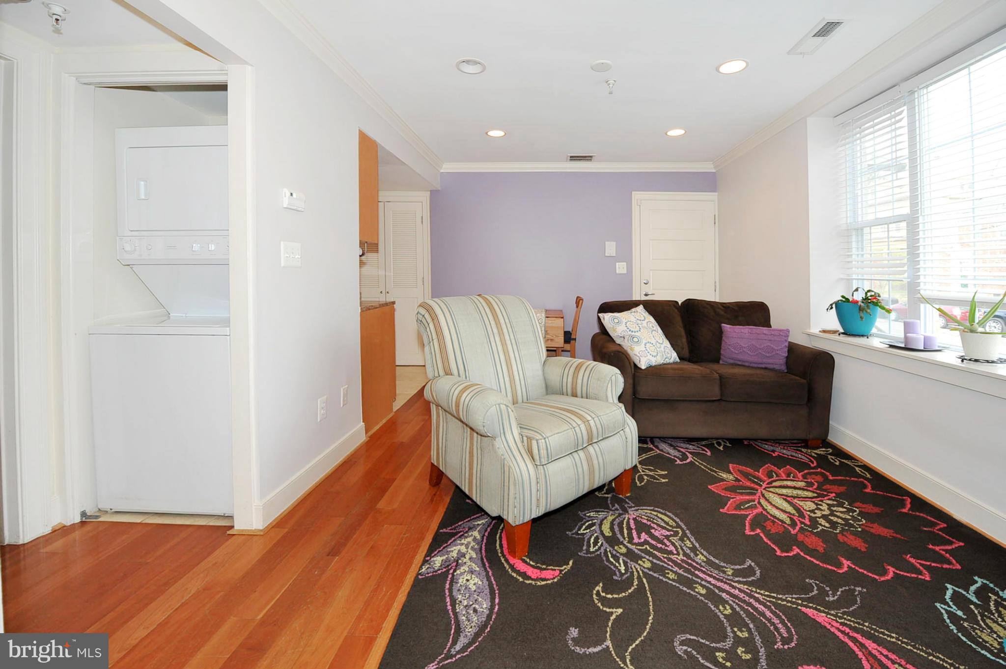 1400 Longfellow Street Northwest, Unit 101 Washington, DC 20011 - Photo 5 of 14 a living room with furniture and a rug