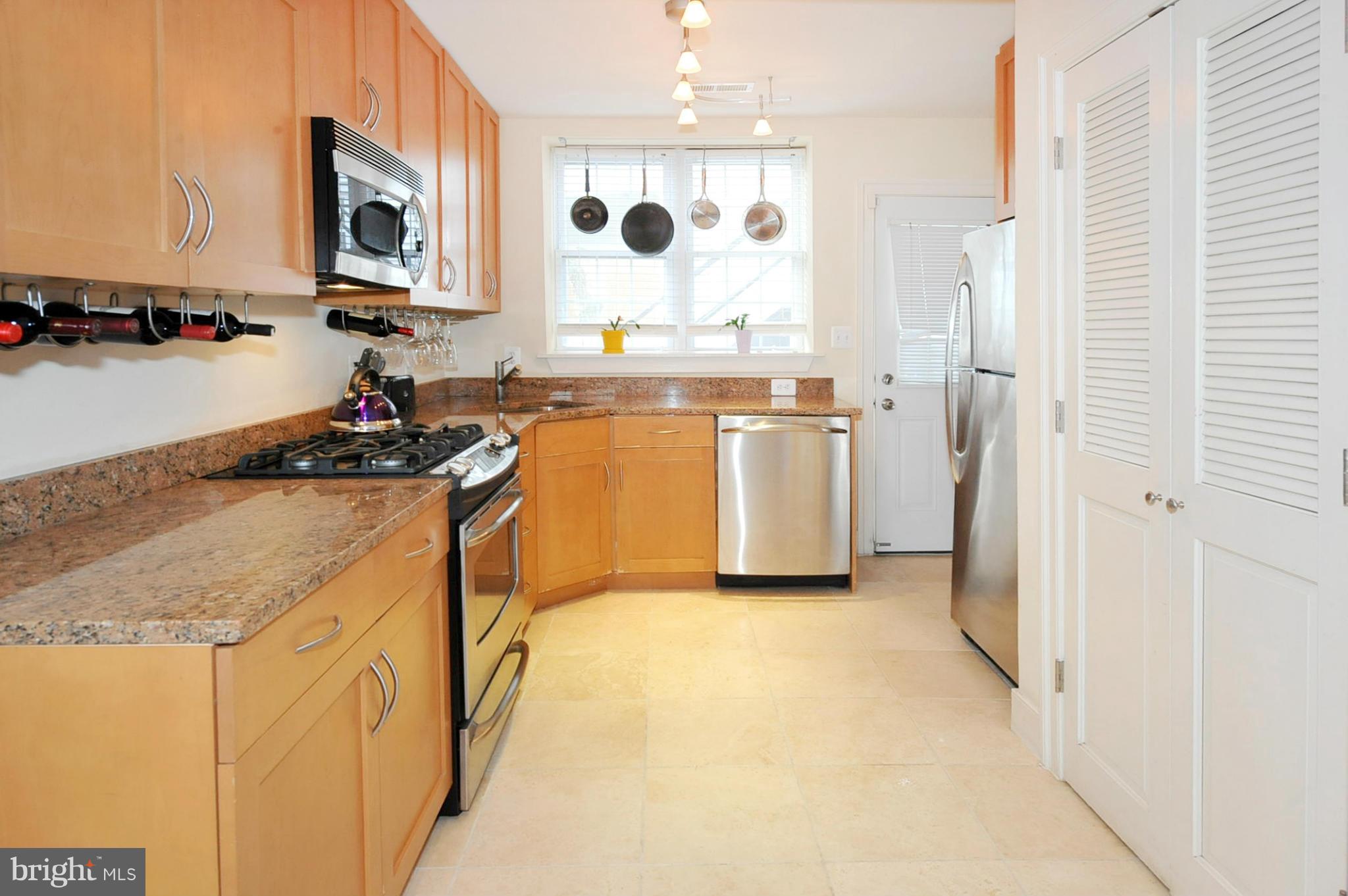 1400 Longfellow Street Northwest, Unit 101 Washington, DC 20011 - Photo 6 of 14 a kitchen with a sink stove and refrigerator