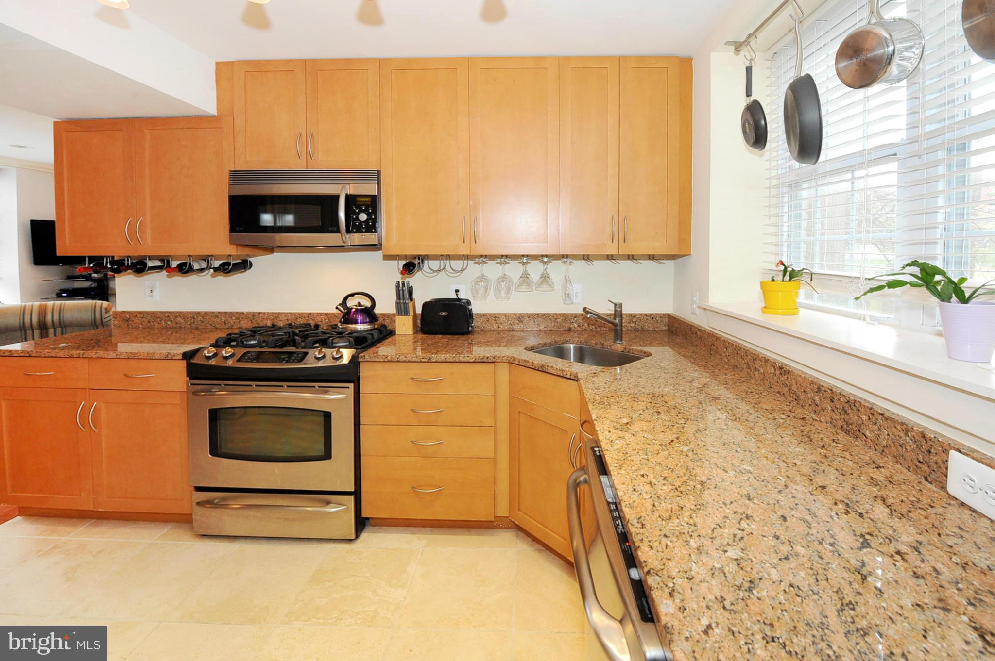 1400 Longfellow Street Northwest, Unit 101 Washington, DC 20011 - Photo 8 of 14 a kitchen with stainless steel appliances a stove a sink and a microwave